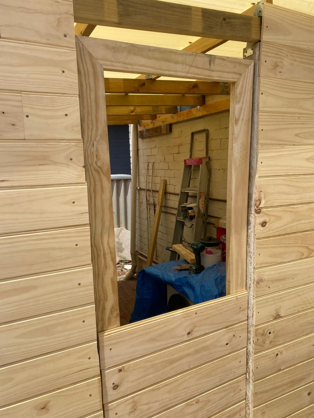 Timber cladding being installed on a garden shed